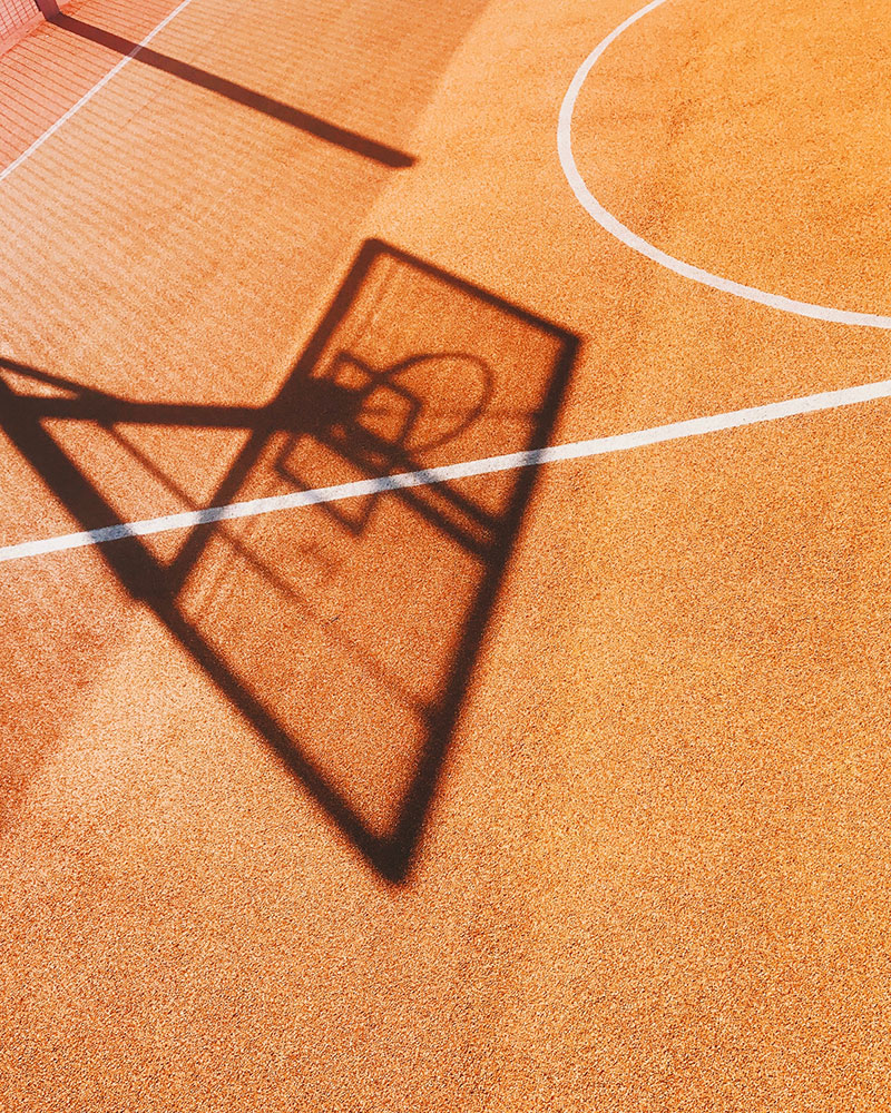 newly paved asphalt basketball court