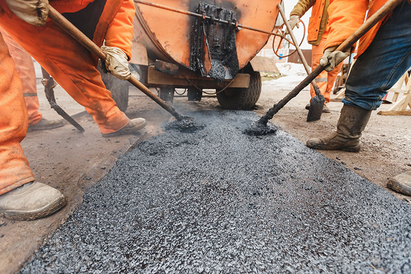 workers doing asphalt pothole repairs